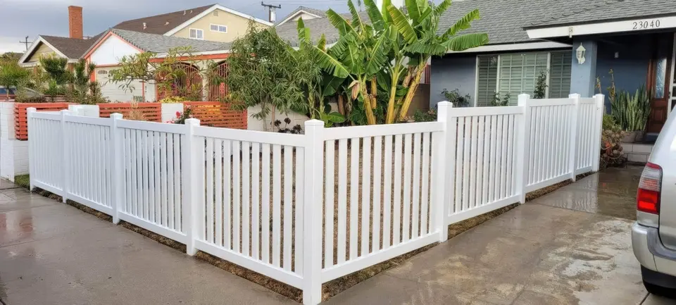 Vinyl picket fence with landscaping